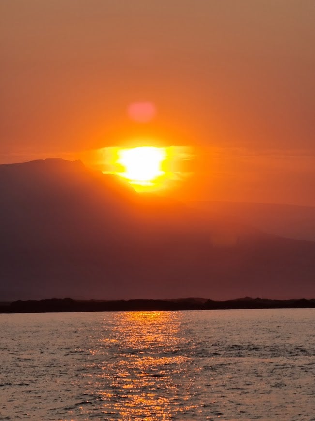 Icelandic summer casts a golden glow in Djupivogur's surrounding fjord and ocean.