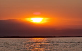 Icelandic summer casts a golden glow in Djupivogur's surrounding fjord and ocean.