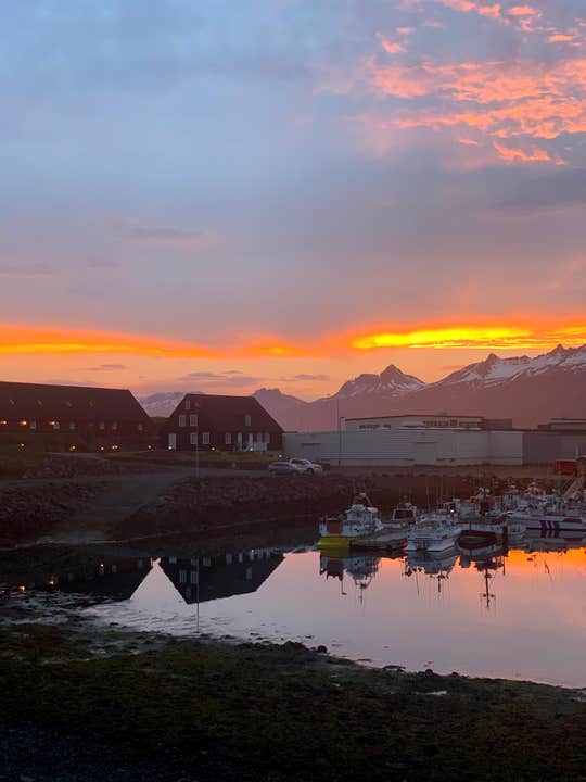 A look at Djupivogur's harbor and surrounding fjord mountains under the midnight sun.