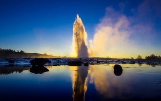 Strokkur Geyser erupting with boiling water in Iceland’s Golden Circle.