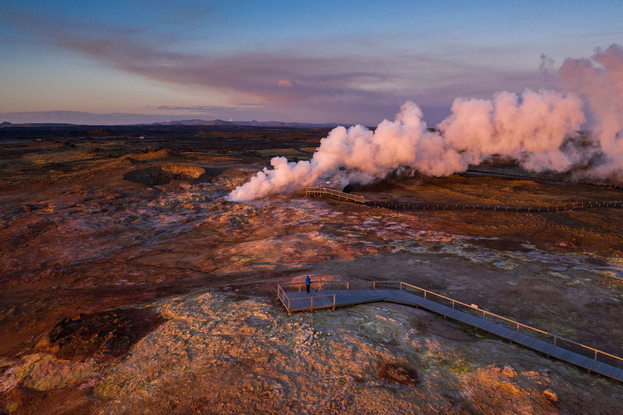 Steam rises from Gunnuhver Hot Springs on the Reykjanes Peninsula at sunset.