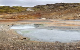 Steaming mud pools and colorful sulphur deposits at the Seltun geothermal area in Reykjanes Peninsula.