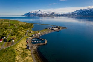 The stunning calm blue waters and mountain backdrop of the Trollaskagi (Troll Peninsula), part of Iceland's Arctic coastline.