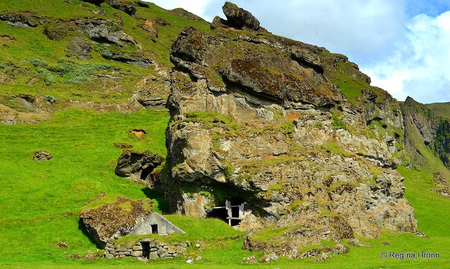 Rutshellir cave dwellings built into a green volcanic hillside, a hidden gem along Iceland's South Coast.