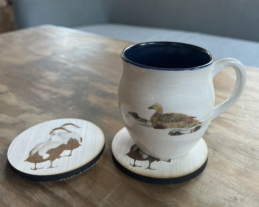 A mug and coasters with an eider duck design being sold at the Icelandic Eider Center in Stykkisholmur, West Iceland.