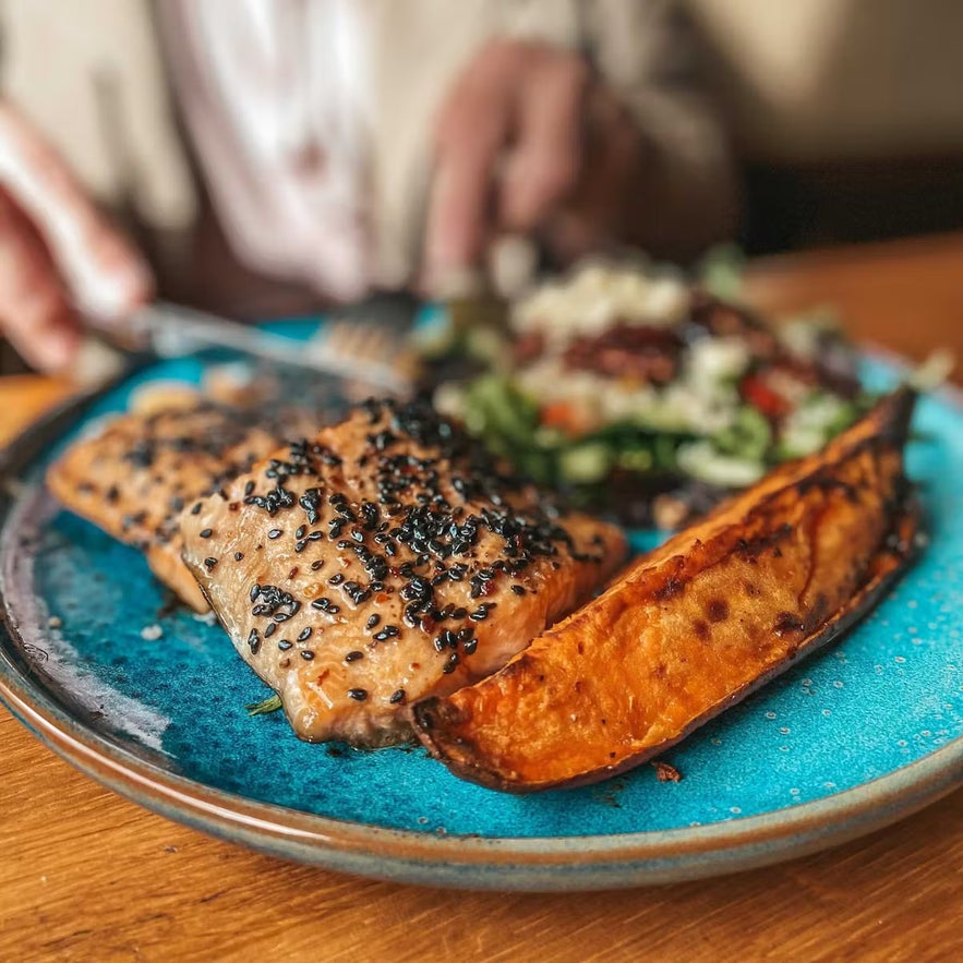 Plate of salmon with sweet potato and salad at Cafe Berlin in Akureyri.