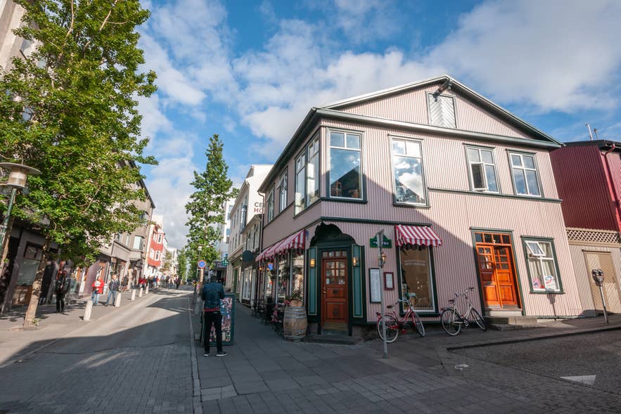 De straat Hverfisgata in Reykjavik, omringd door kleurrijke gebouwen en geparkeerde fietsen.