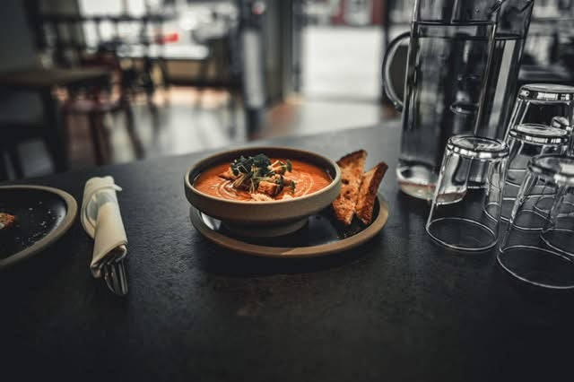 Bowl of tomato soup with bread, served at LYST in Pennin Eymundsson Bookstore in Akureyri.