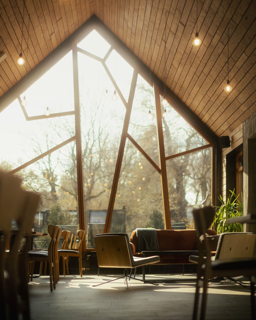 Interior of LYST in Akureyri Botanical Garden features a high wooden ceiling and bright natural light from large windows.