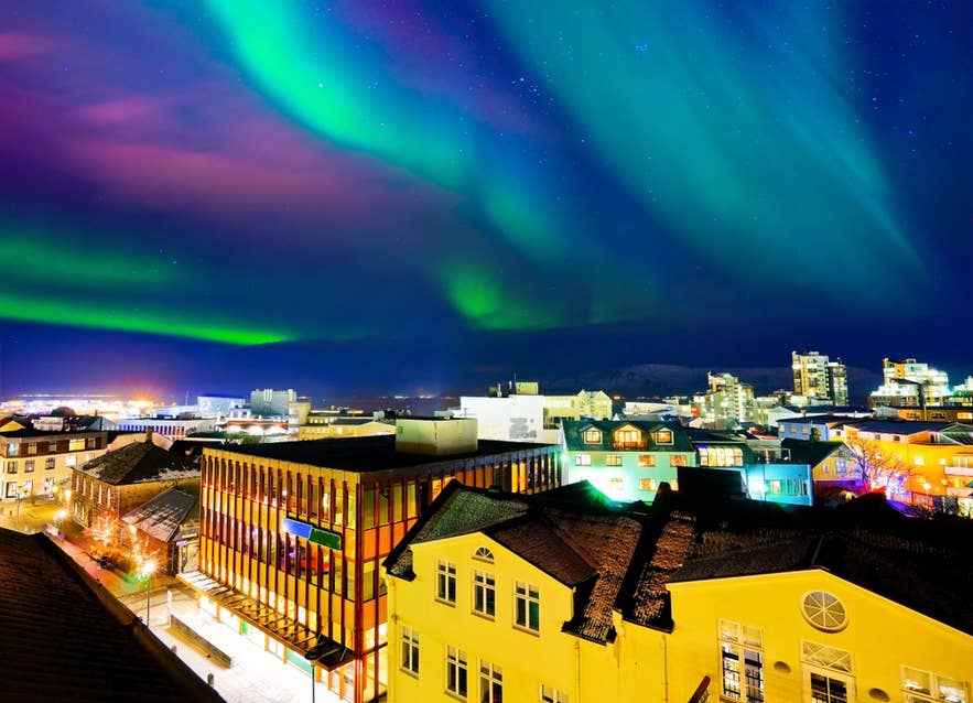 Reykjavik at night illuminated by the stunning northern lights