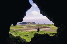 Inside the Loftsalahellir cave, overlooking Dyrholaey and the black sand beach.