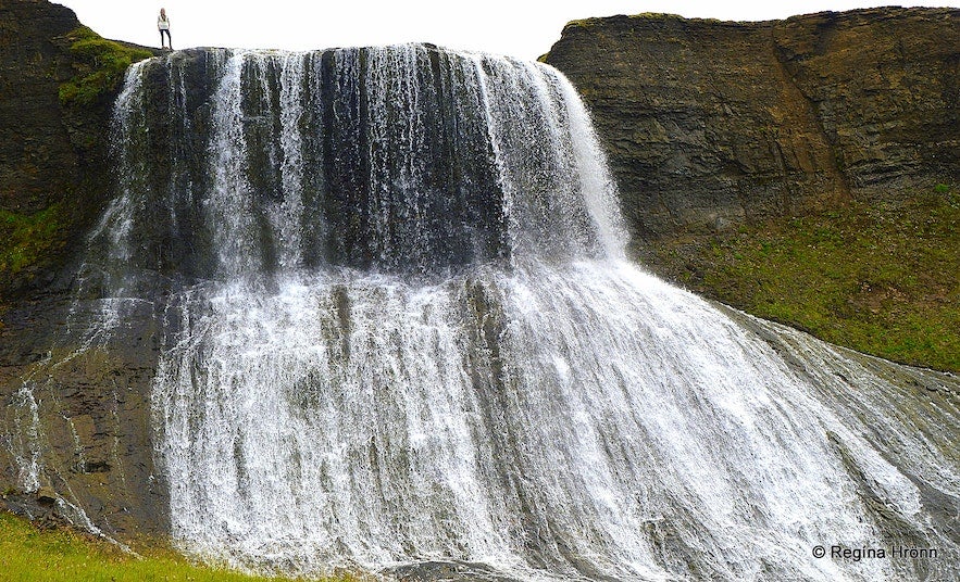 Tourists can easily stand on top of the Hvitserkur waterfall.