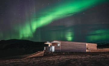Le Black Beach Suites, sur la Côte Sud de l'Islande, sous l'éclat des aurores boréales.