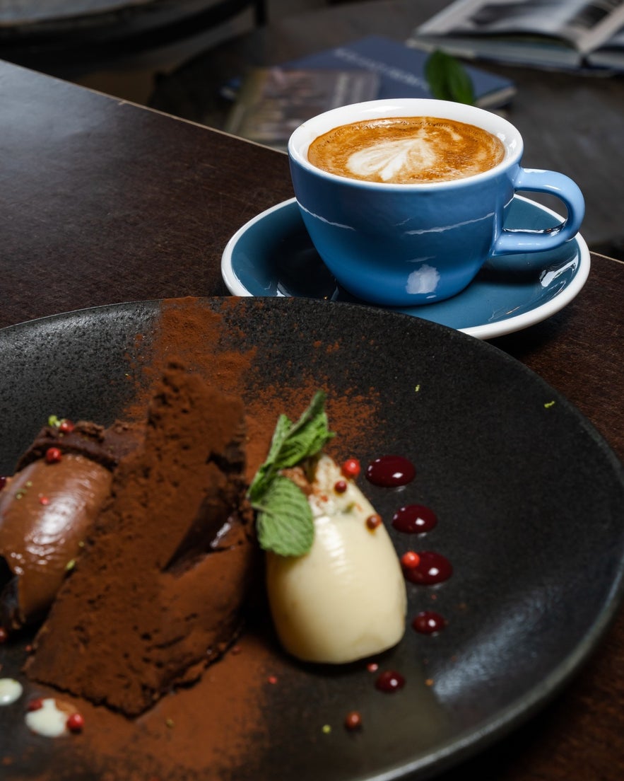 Latte with heart foam and chocolate dessert.