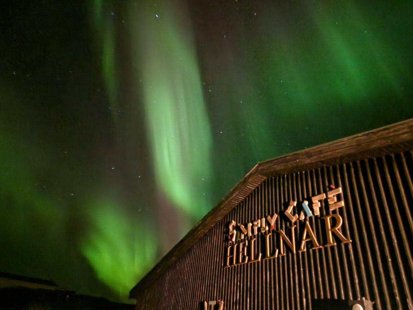 Exterior of Simply Café beneath the northern lights.