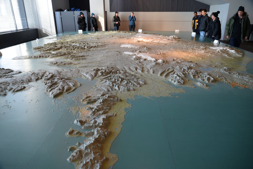 Giant 3D relief map of Iceland inside Reykjavik City Hall, showing mountains, glaciers, and coastlines for trip planning