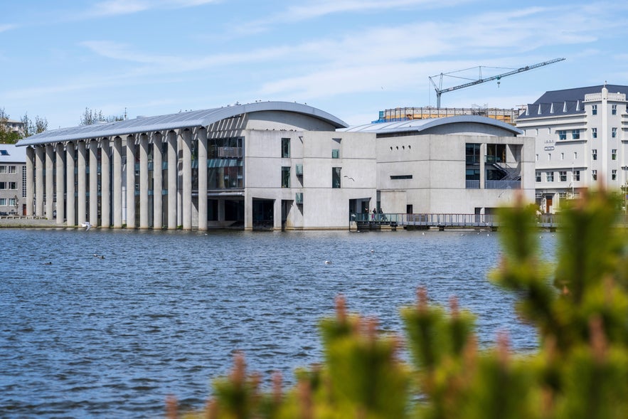 Reykjavik City Hall seemingly floating on Tjornin Pond in Iceland.