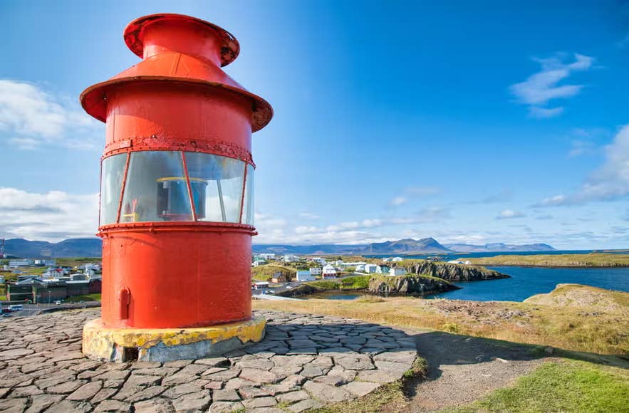 Red lighthouse above Stykkisholmur harbor on Snaefellsnes, one of the seven Icelandic Met Office weather stations.