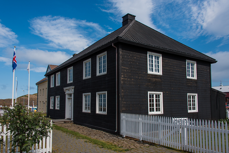 Historic Norwegian House under blue skies in Stykkisholmur.