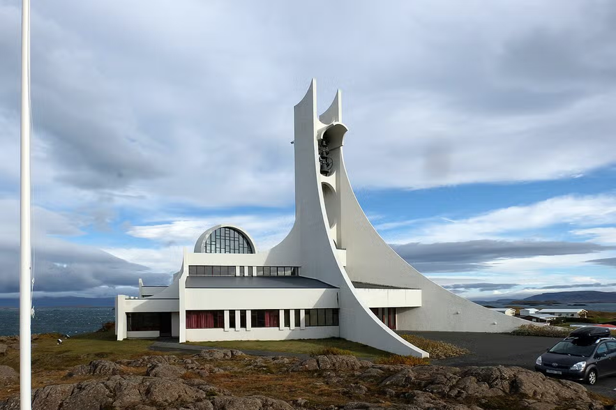 Stykkisholmskirkja with curved architecture overlooking the sea in Iceland.