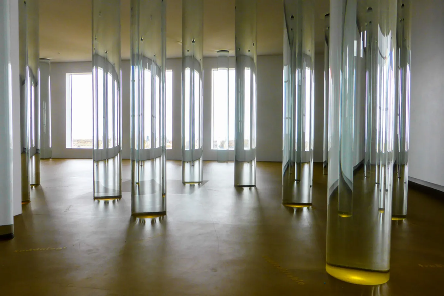 Glass pillars filled with glacial water inside the Library of Water in Stykkisholmur, Iceland.