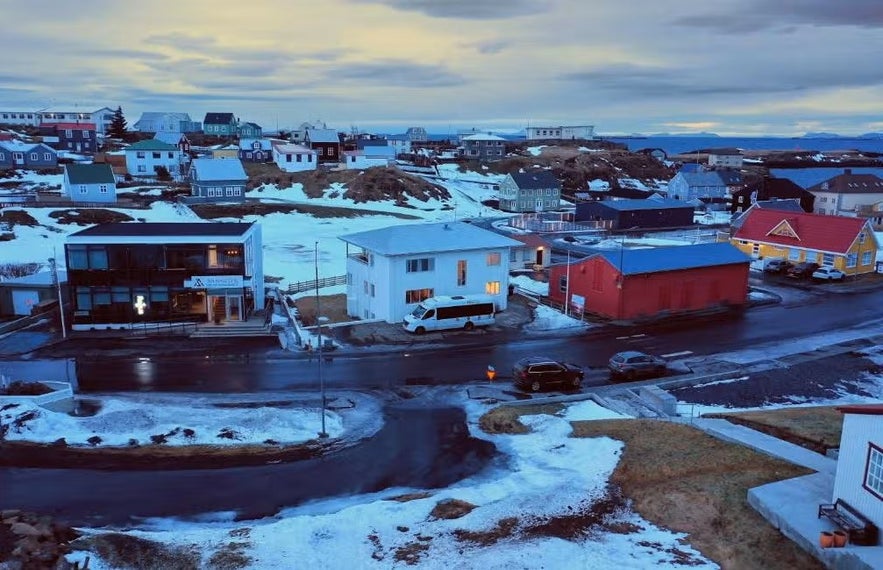 Snowy streets and colorful houses in Stykkisholmur Iceland during winter dusk.
