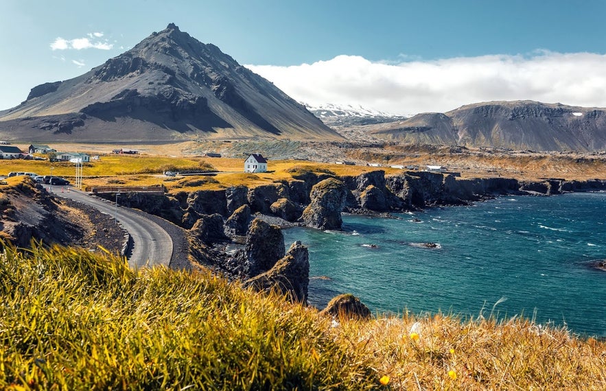 Scenic coastal cliffs and mountain landscape near Arnarstapi in West Iceland.