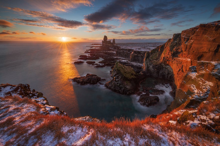 Sunset over Londrangar cliffs and sea stacks on the Snaefellsnes Peninsula in Iceland.
