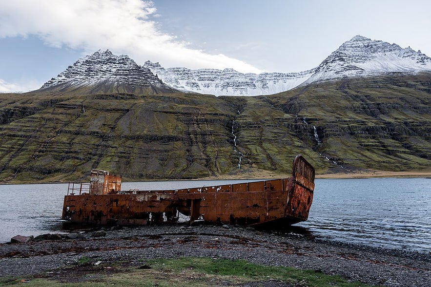 The shipwrecked US Navy ship on the shores of the Mjoifjordur fjord.