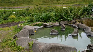 The Westfjords of Iceland is rich in geothermal pools, including Nauteyrarlaug and its nearby Hellulaug hot spring seen on this photo.