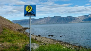 A warning sign about sea monsters on the shores of  Arnarfjordur fjord in the Westfjords