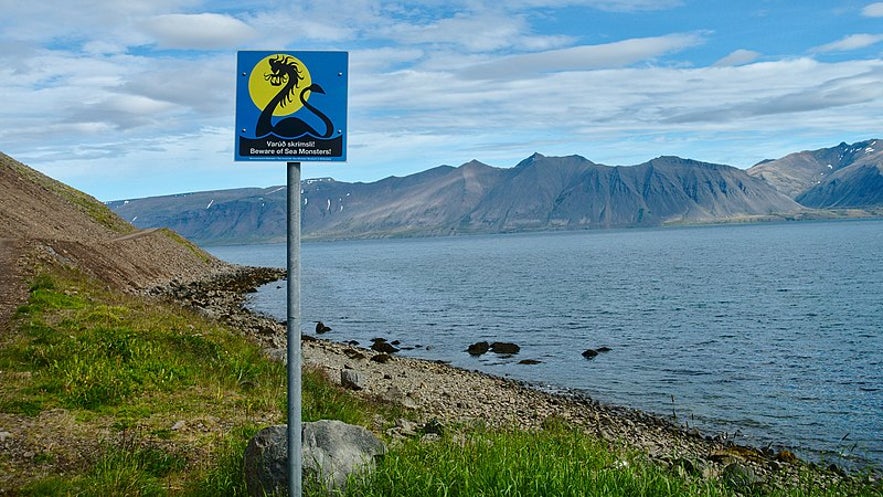 A warning sign about sea monsters on the shores of  Arnarfjordur fjord in the Westfjords