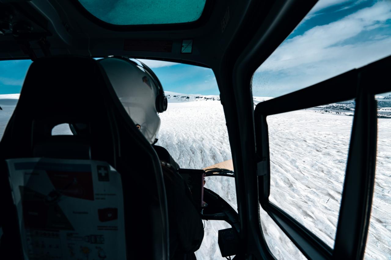 Pilot guiding a helicopter toward a glacier landing on Langjokull in Iceland.