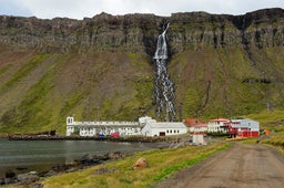 The village of Djupavik, with Djupavikurfoss waterfall tumbling down.