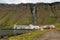 The village of Djupavik, with Djupavikurfoss waterfall tumbling down.