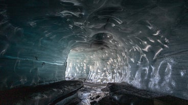 Volcanic ash patterns swirling through the glacier ice of Katla Ice Cave.