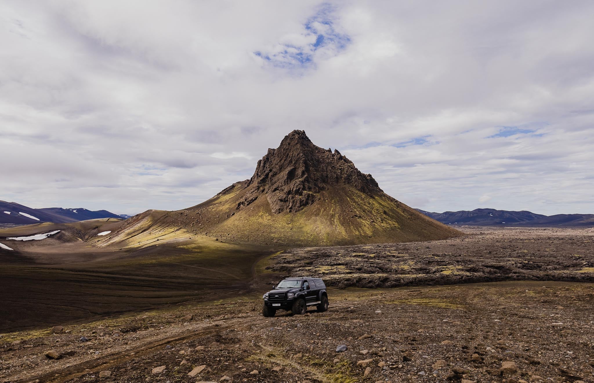 A black super jeep vehicle is seen parked in the Icelandic Highlands.