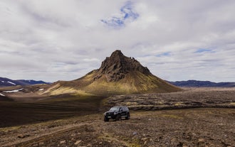 A black super jeep vehicle is seen parked in the Icelandic Highlands.