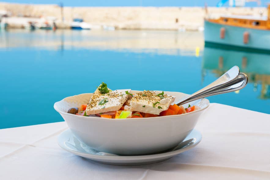 Greek salad with feta cheese on a table.
