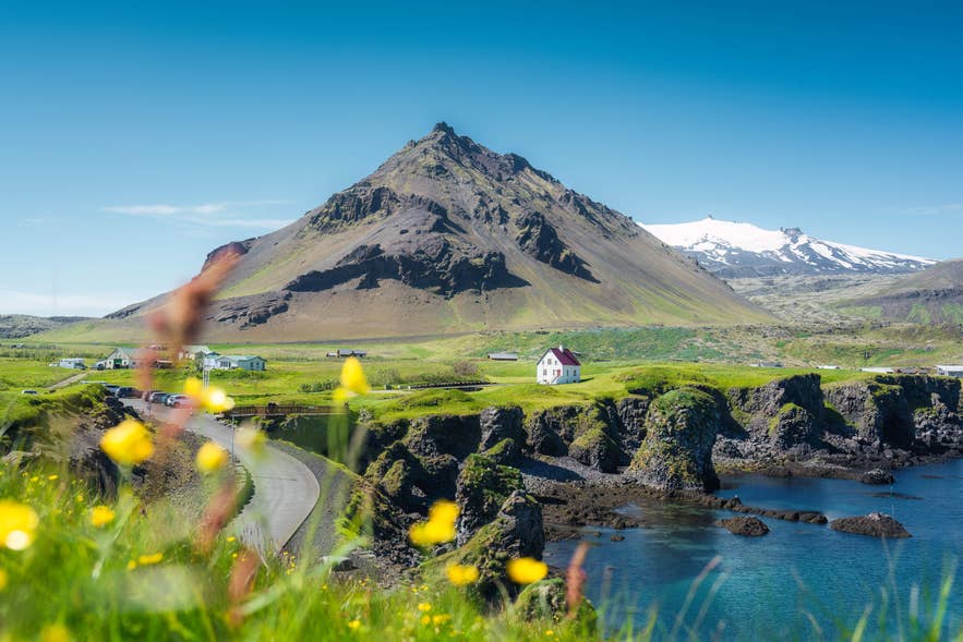 Beautiful view of Arnarstapi fishing village with nordic house and Stapafell volcano mountain.