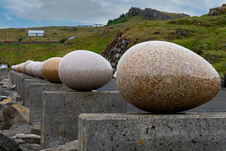 Close-up of granite bird egg sculptures at Eggin í Gleðivík art installation in Djúpivogur, East Iceland.