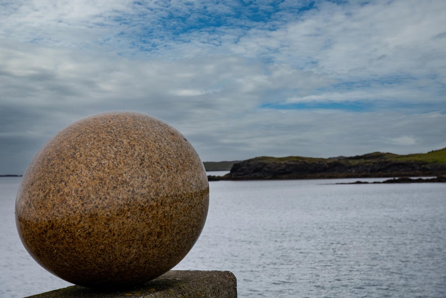 Granite egg sculpture at Eggin í Gleðivík overlooking the harbor in Djúpivogur, East Iceland.
