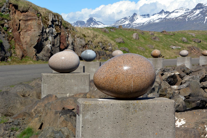 Eggin í Gleðivík granite sculptures with snow-capped mountains in the background near Djúpivogur, East Iceland.