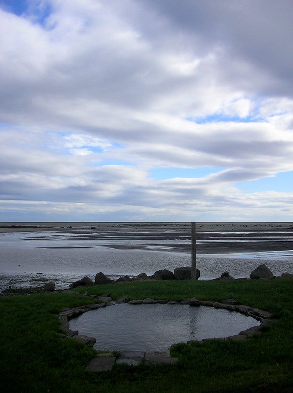 The natural pool at the Krosslaug hot springs has an ocean view. The natural pool at the Krosslaug hot springs has an ocean view.