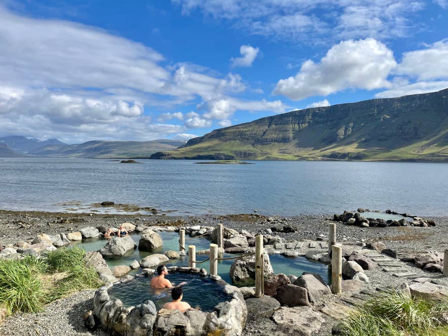 Hvammsvik Hot Springs in Hvalfjordur is one of the hidden gems in Iceland with natural pools and mountain views.