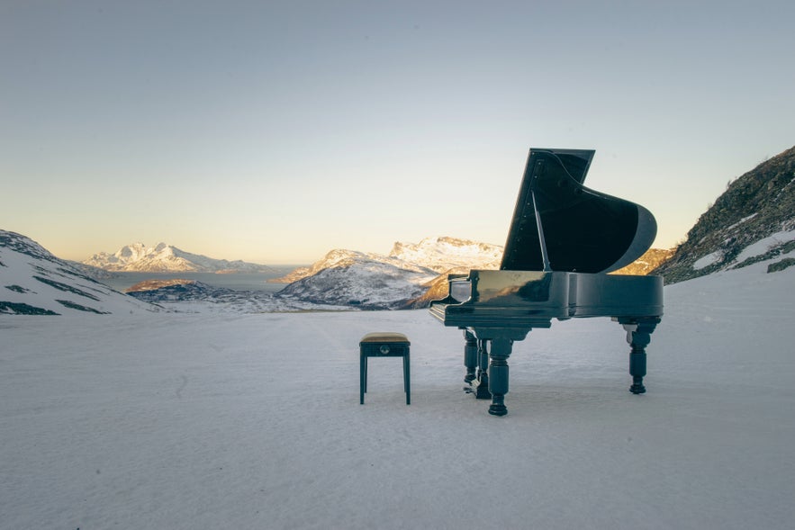 Grand piano on snowy Icelandic mountain.
