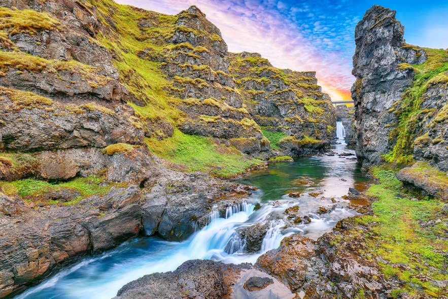 Kolugljufur Canyon in North Iceland is one of the hidden gems in Iceland with Kolufossar Waterfalls and rugged cliffs.