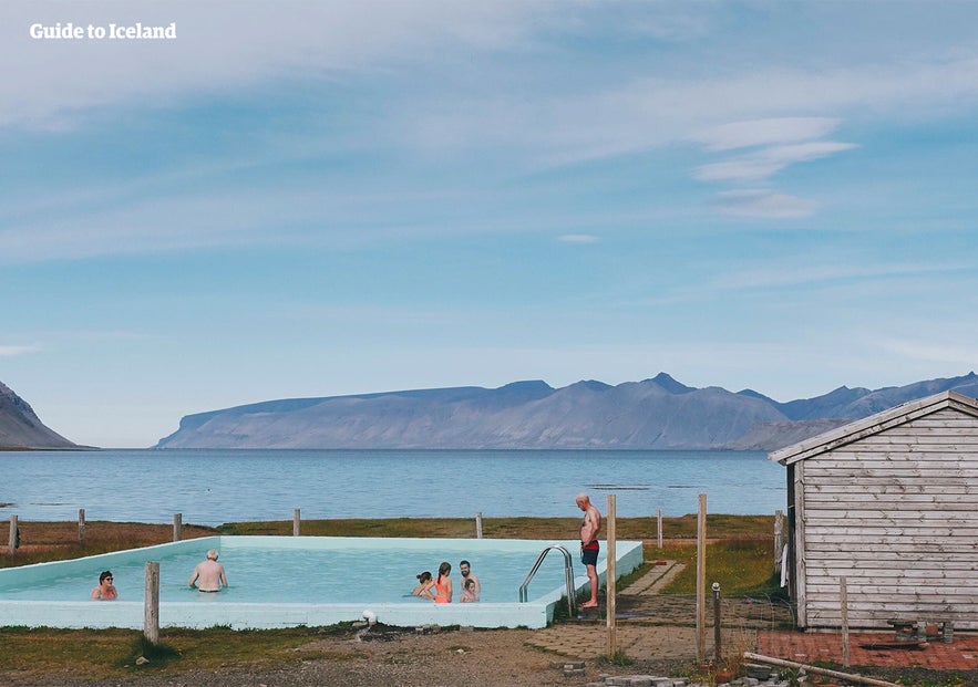 A group enjoys a soak in the pool at Reykjafjardarlaug hot spring. A group enjoys a soak in the pool at Reykjafjardarlaug hot spring.