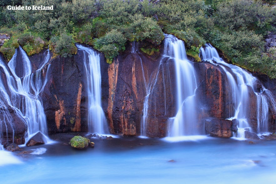 Hraunfossar waterfall cascades down lava rocks in West Iceland