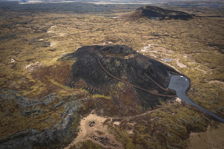 Aerial view of Saxholl Crater in Snaefellsnes Peninsula, Iceland, showing hiking trails and volcanic landscapes around Saxholl. Aerial view of Saxholl Crater in Snaefellsnes Peninsula, Iceland, showing hiking trails and volcanic landscapes around Saxholl.